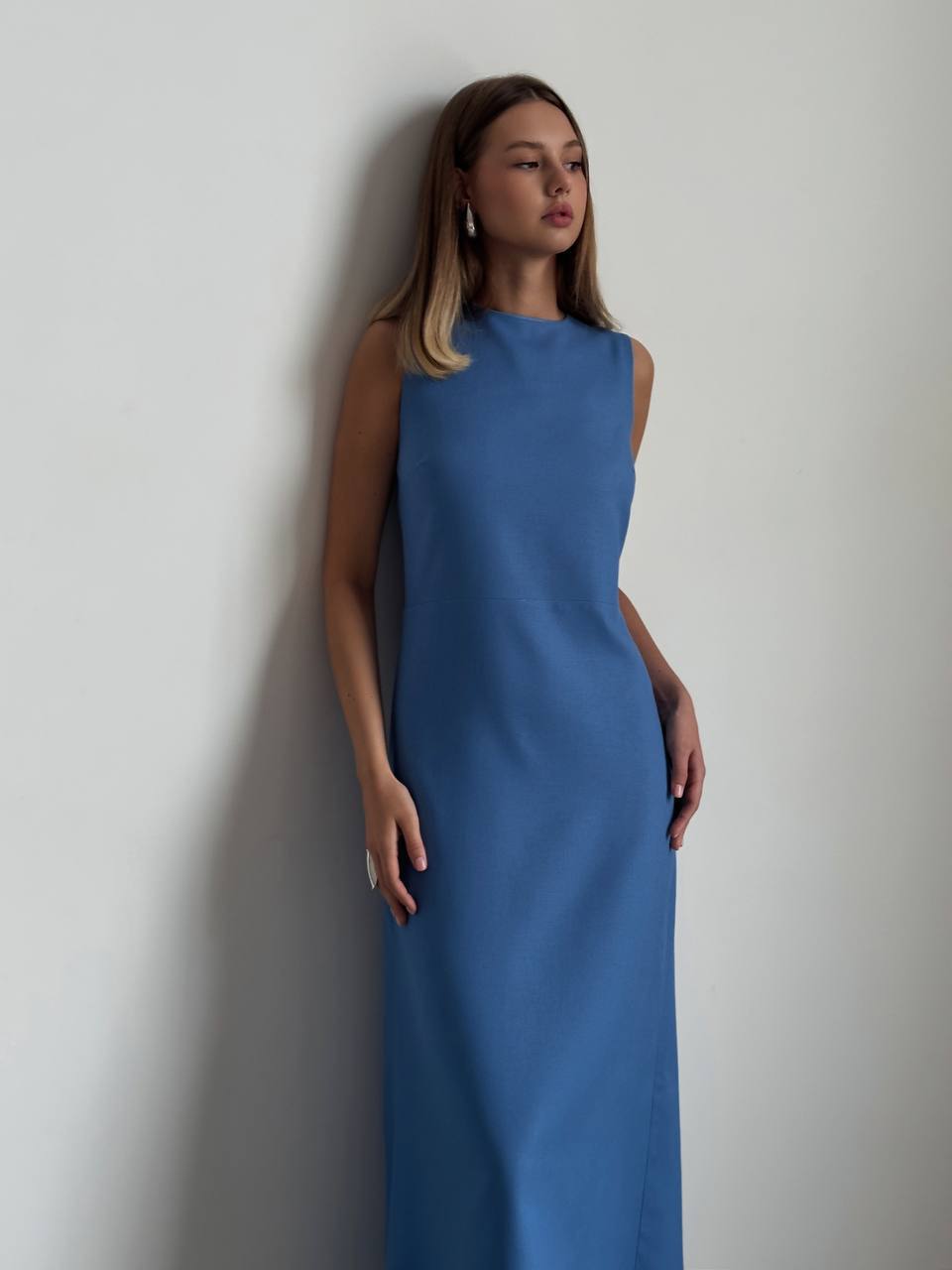 Woman wearing a blue dress against a plain background