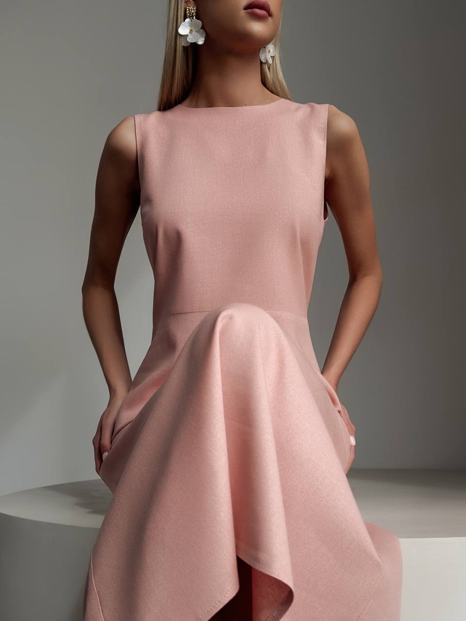 Pink dress worn by a model against a neutral background