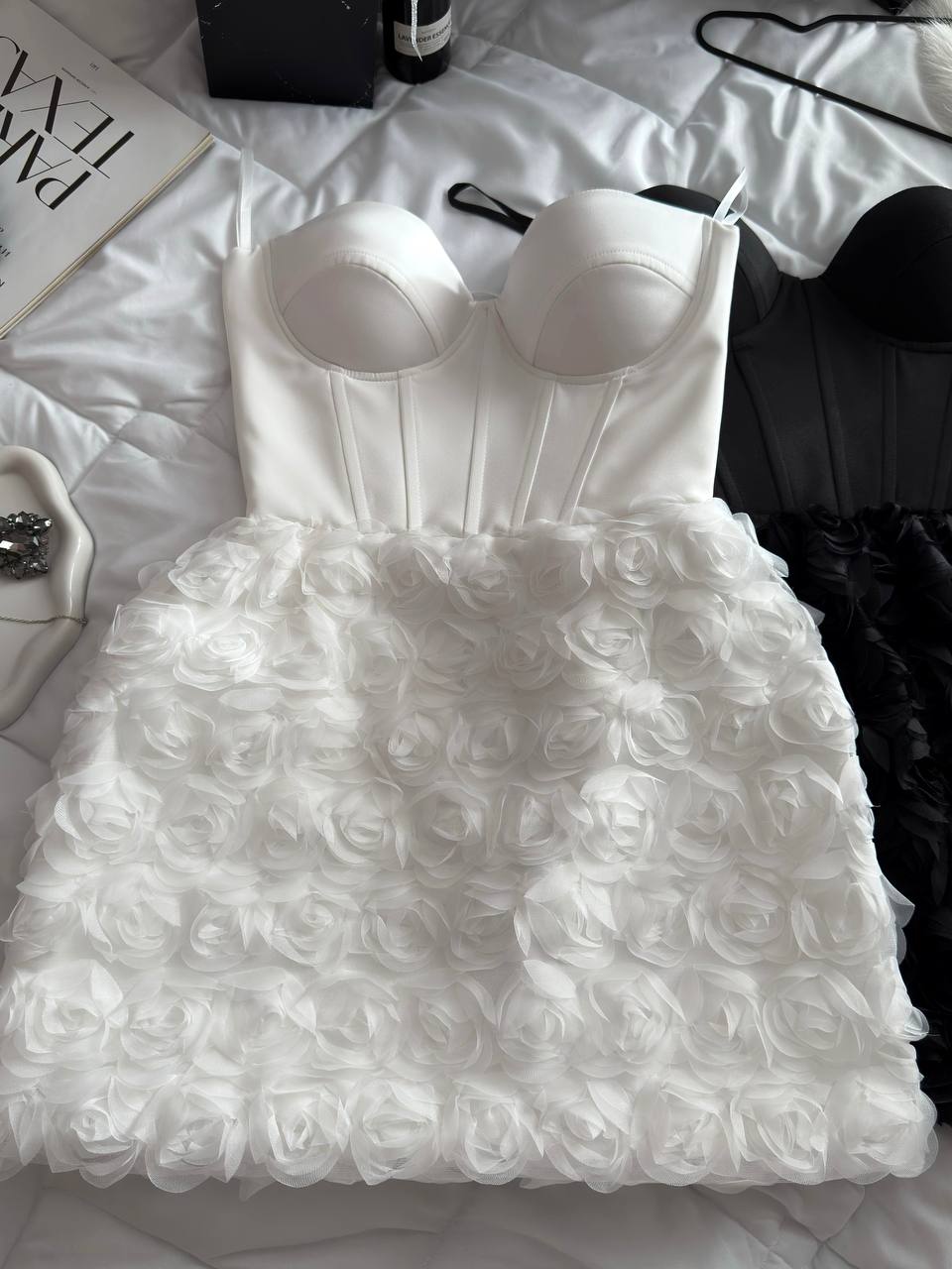 White dress with floral details on a white surface