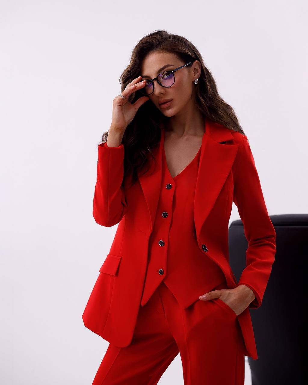 Woman wearing a red suit with a white background