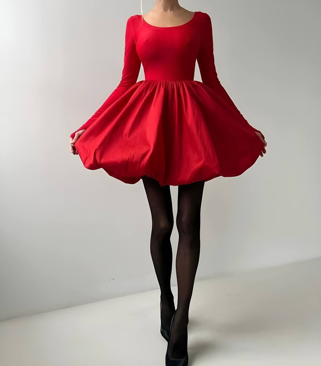 Red dress with long sleeves on a plain background