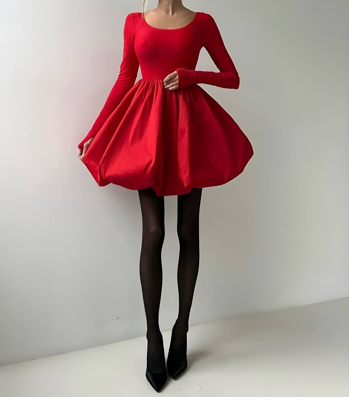 Red dress with long sleeves on a plain background