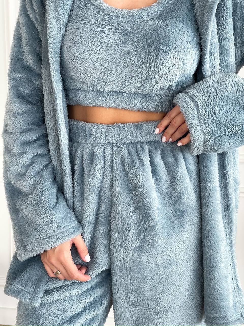 Blue fluffy loungewear set with matching robe on a neutral background