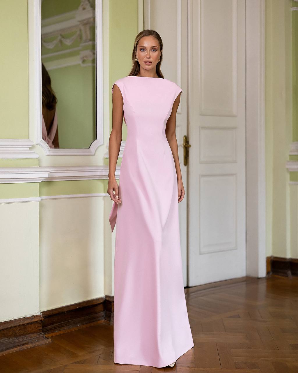 Woman wearing a pink evening gown in an elegant interior setting