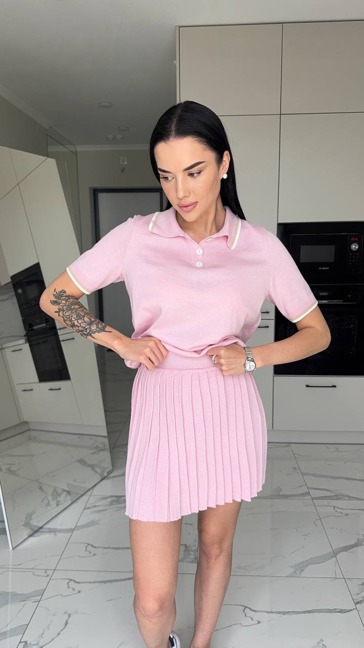 Woman wearing a pink dress in a modern kitchen