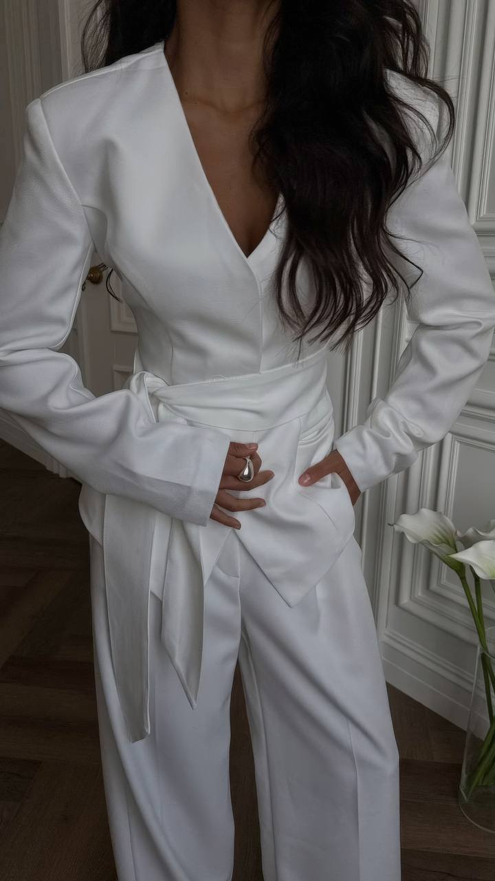 Person wearing a white jumpsuit with a blurred background